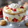 The Best Strawberry Banana Pudding in a glass trifle bowl with fruit and cookies